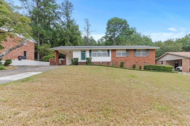 ranch-style home with a carport and a front yard