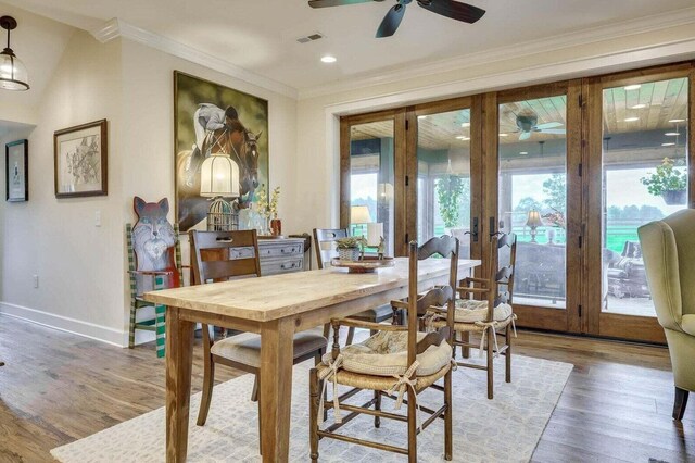 dining room featuring french doors, hardwood / wood-style floors, and ornamental molding