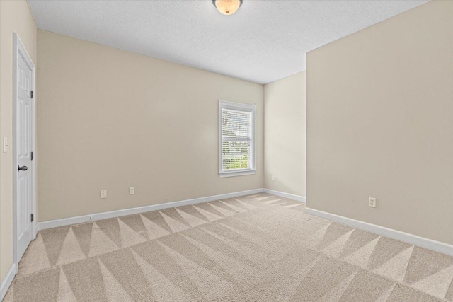 carpeted spare room featuring a textured ceiling