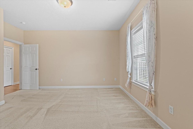 carpeted spare room with plenty of natural light