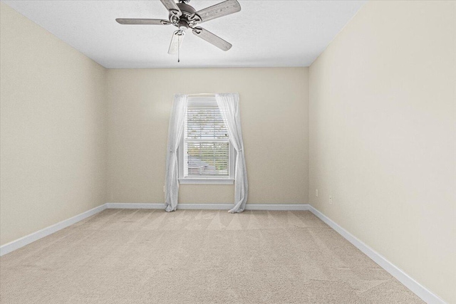 unfurnished room featuring ceiling fan and light colored carpet