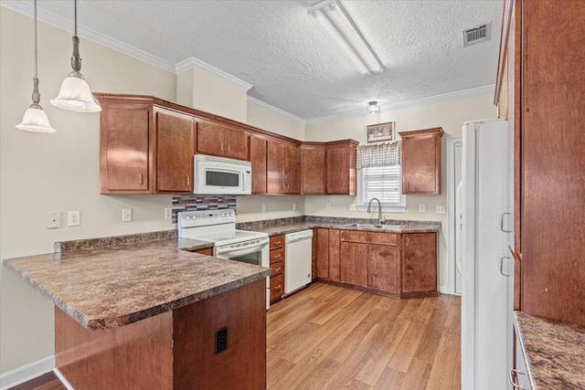 kitchen with sink, kitchen peninsula, a textured ceiling, decorative light fixtures, and white appliances