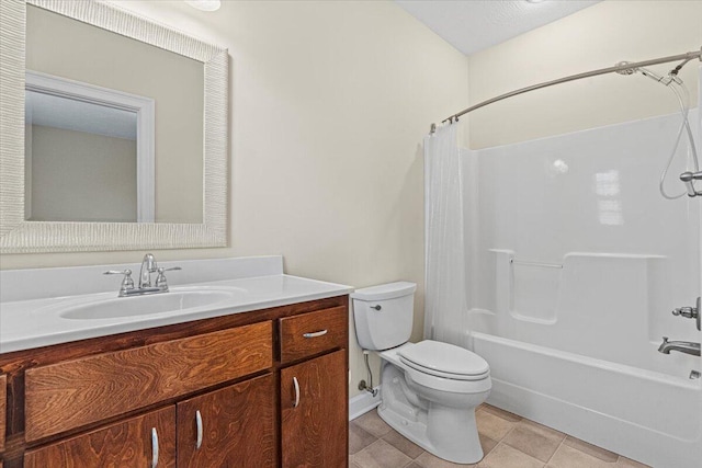 full bathroom featuring shower / bath combo, tile patterned floors, vanity, a textured ceiling, and toilet