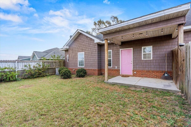 back of house featuring a yard and a patio