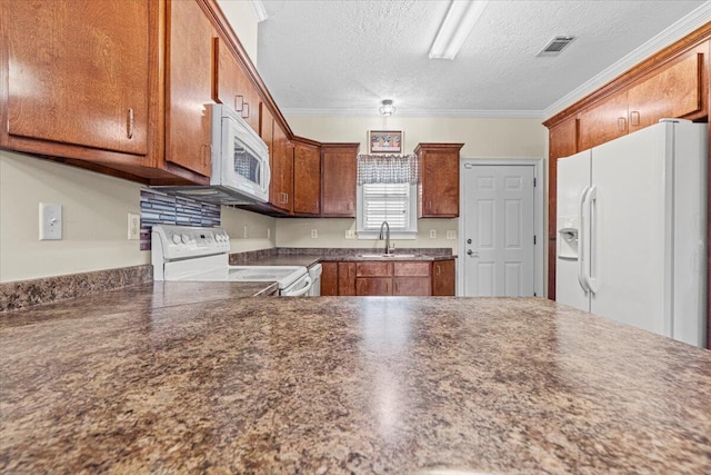 kitchen with a textured ceiling, sink, white appliances, and ornamental molding