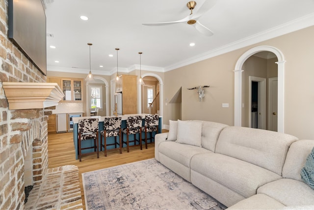 636 Railroad Ave, North Augusta, SC 29841 - living room featuring arched walkways, a ceiling fan, crown molding, light wood finished floors, and a fireplace