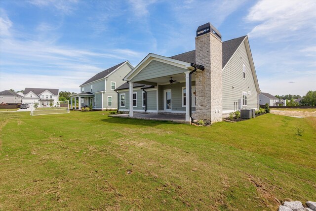 856 Whitney Shoals Rd, Evans, GA 30809 - back of property with ceiling fan, a chimney, a lawn, and cooling unit