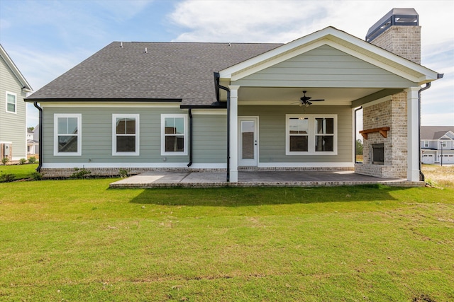 856 Whitney Shoals Rd, Evans, GA 30809 - back of house with a fireplace, a ceiling fan, a patio area, a chimney, and a lawn