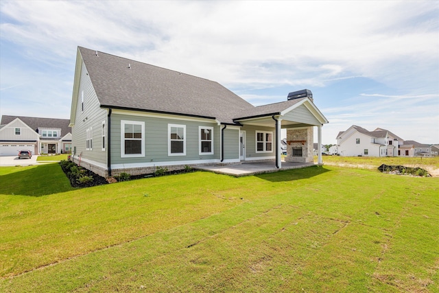856 Whitney Shoals Rd, Evans, GA 30809 - back of property featuring a lawn, a patio area, a chimney, and roof with shingles
