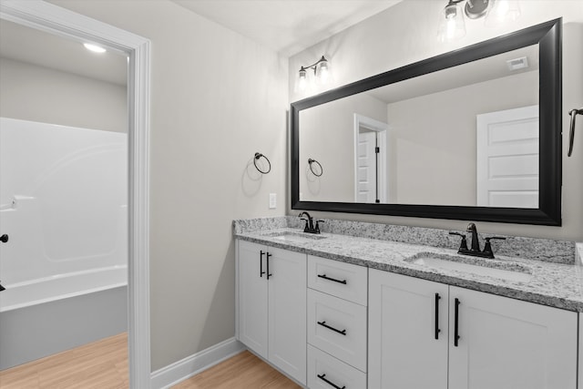 856 Whitney Shoals Rd, Evans, GA 30809 - full bathroom featuring wood finished floors, double vanity, a bathtub, and baseboards