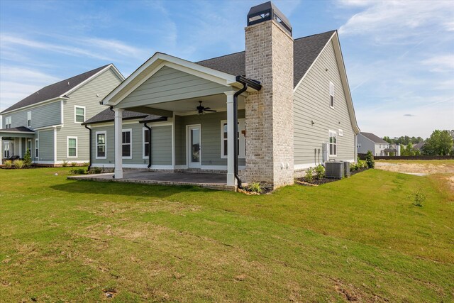 856 Whitney Shoals Rd, Evans, GA 30809 - rear view of house featuring ceiling fan, a yard, a chimney, and roof with shingles