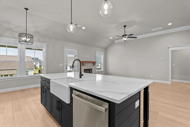 856 Whitney Shoals Rd, Evans, GA 30809 - kitchen featuring dark cabinets, stainless steel dishwasher, a sink, a fireplace, and lofted ceiling