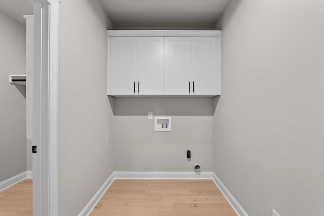 856 Whitney Shoals Rd, Evans, GA 30809 - clothes washing area with light wood finished floors, washer hookup, baseboards, and cabinet space