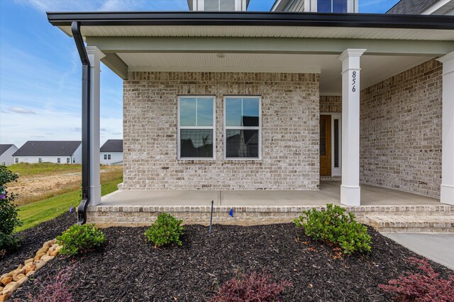 856 Whitney Shoals Rd, Evans, GA 30809 - view of exterior entry featuring covered porch and brick siding
