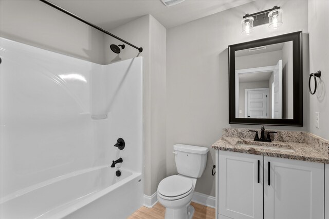 856 Whitney Shoals Rd, Evans, GA 30809 - bathroom with wood finished floors, toilet, tub / shower combination, vanity, and baseboards