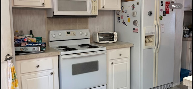 kitchen with white cabinetry, white appliances, and tasteful backsplash