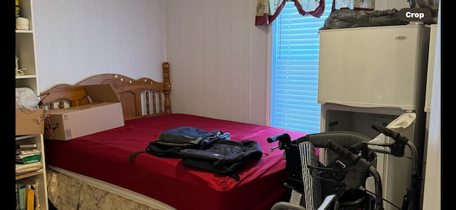 bedroom featuring refrigerator