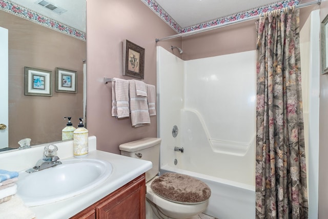 bathroom featuring toilet, vanity, visible vents, and shower / tub combo with curtain