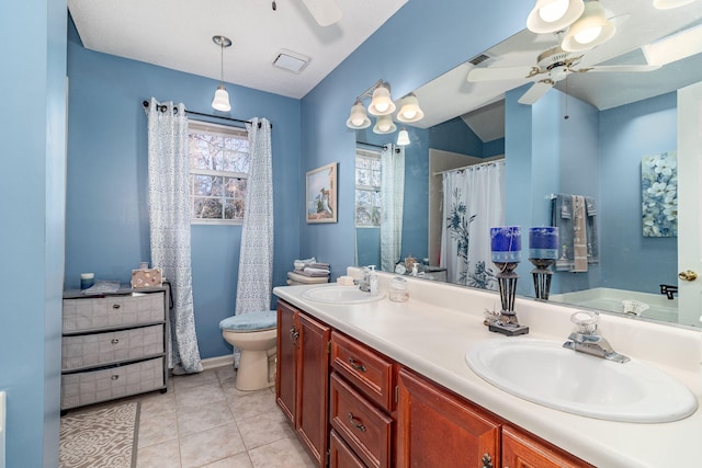 full bath featuring double vanity, a sink, a ceiling fan, and tile patterned floors