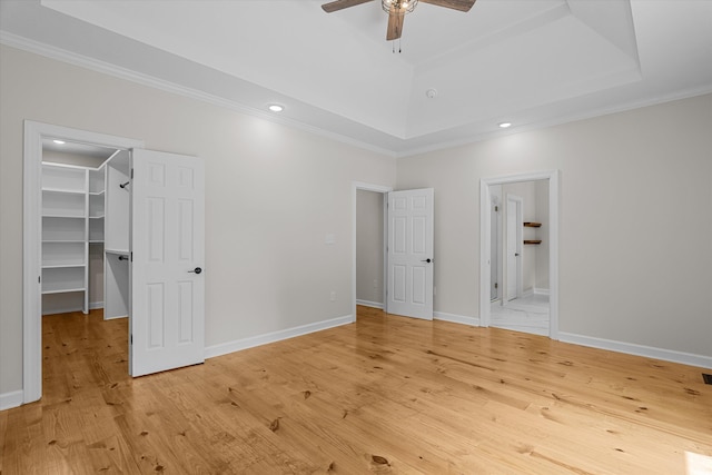 473 Sugarcreek Dr, Grovetown, GA 30813 - unfurnished bedroom with a spacious closet, ornamental molding, a raised ceiling, light wood-style flooring, and a closet