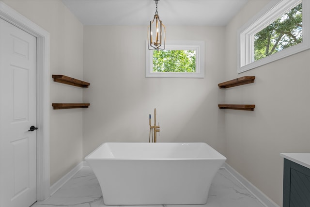 473 Sugarcreek Dr, Grovetown, GA 30813 - bathroom featuring marble look tile flooring, a freestanding bath, vanity, and baseboards
