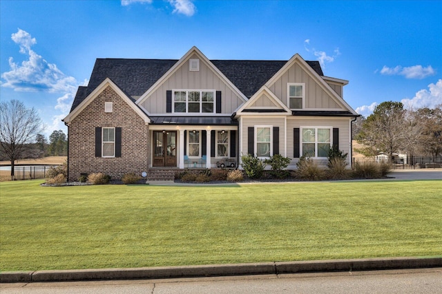 craftsman-style house with a front lawn and covered porch