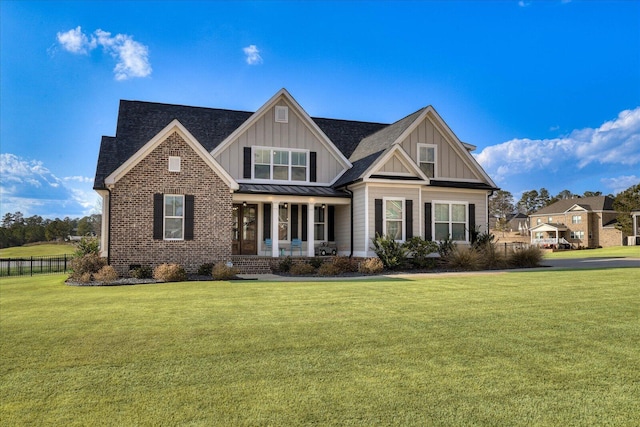 craftsman house with covered porch and a front lawn