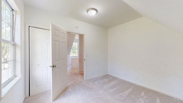 122 Ehrlich Farm Rd, Swainsboro, GA 30401 - unfurnished bedroom with light colored carpet, vaulted ceiling, and a closet