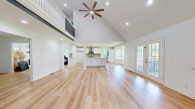 122 Ehrlich Farm Rd, Swainsboro, GA 30401 - unfurnished living room with high vaulted ceiling, a ceiling fan, french doors, light wood-style flooring, and plenty of natural light