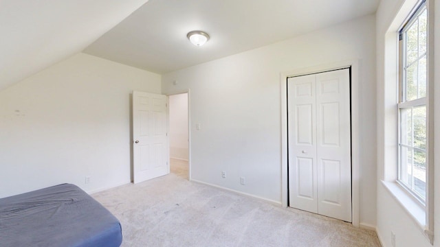 122 Ehrlich Farm Rd, Swainsboro, GA 30401 - unfurnished bedroom featuring light carpet, vaulted ceiling, and a closet