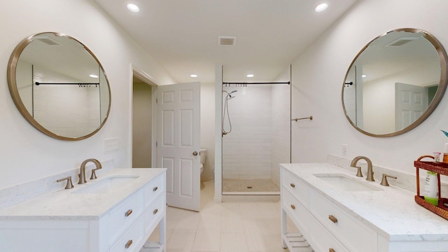 122 Ehrlich Farm Rd, Swainsboro, GA 30401 - bathroom featuring two vanities, tiled shower, and recessed lighting