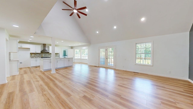 122 Ehrlich Farm Rd, Swainsboro, GA 30401 - unfurnished living room with a ceiling fan, high vaulted ceiling, light wood-style flooring, and recessed lighting