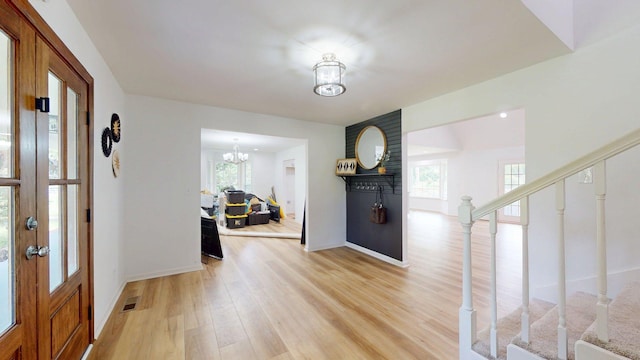 122 Ehrlich Farm Rd, Swainsboro, GA 30401 - foyer entrance featuring stairway, light wood-style flooring, and a chandelier
