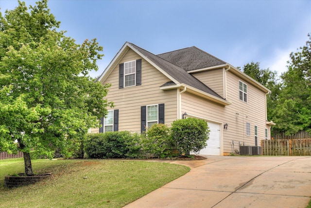 view of side of home featuring concrete driveway, an attached garage, and central AC unit