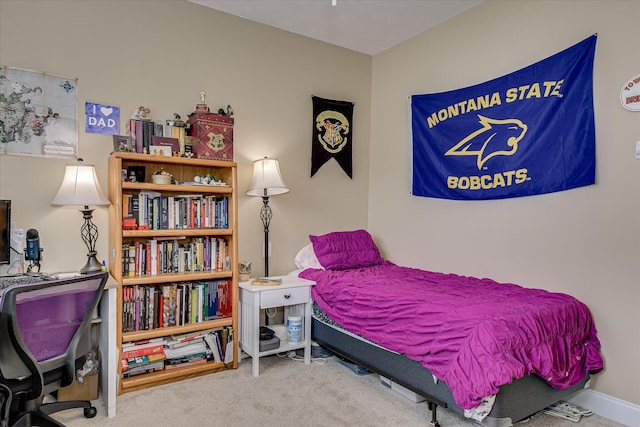 carpeted bedroom featuring an office area
