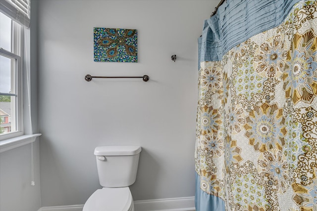 full bathroom with baseboards and toilet