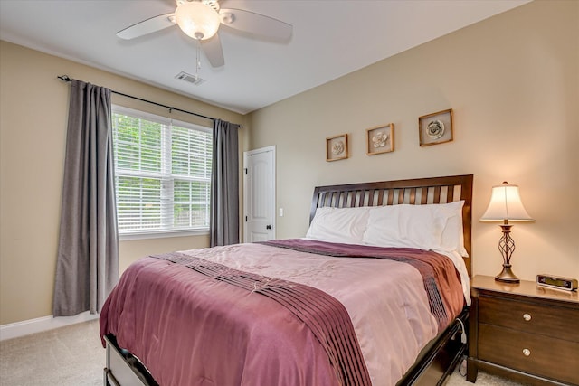 bedroom with light colored carpet, baseboards, and ceiling fan