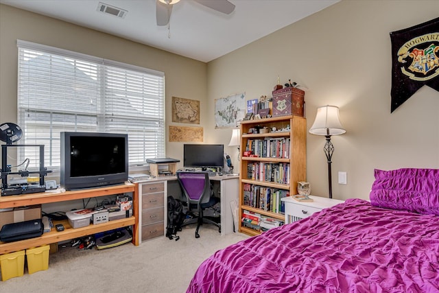 bedroom with carpet flooring, multiple windows, and an office area