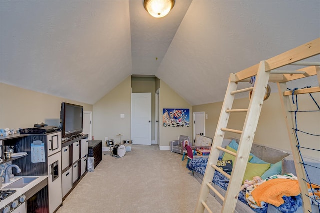 bedroom with light colored carpet, lofted ceiling, and a sink