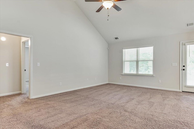 carpeted spare room with a ceiling fan, high vaulted ceiling, visible vents, and baseboards