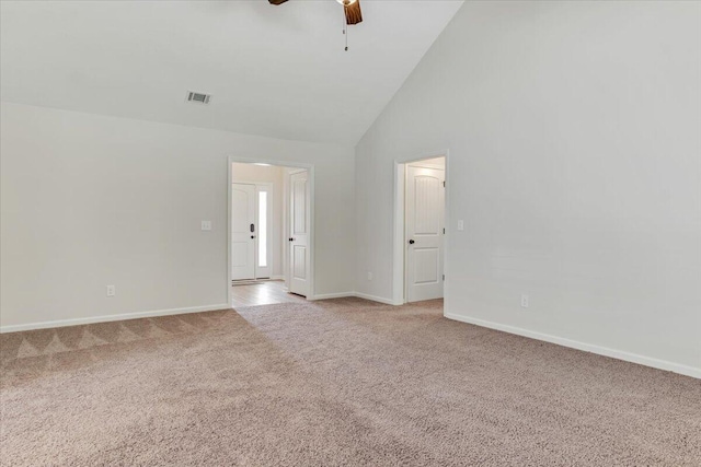 unfurnished room featuring ceiling fan, visible vents, light colored carpet, baseboards, and high vaulted ceiling