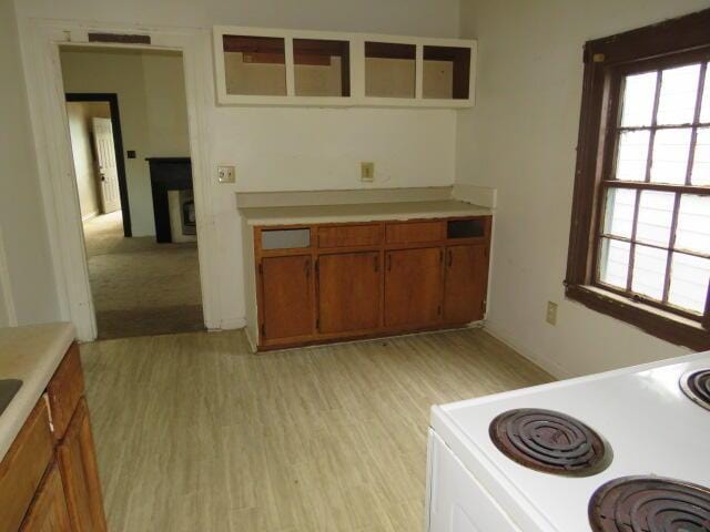 1916 Walker St, Augusta, GA 30904 - kitchen featuring brown cabinets, light countertops, electric stove, and plenty of natural light