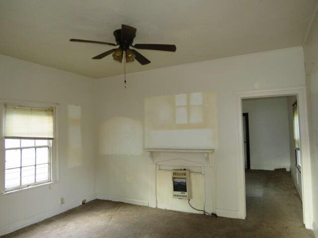1916 Walker St, Augusta, GA 30904 - unfurnished living room featuring heating unit, carpet floors, and a ceiling fan