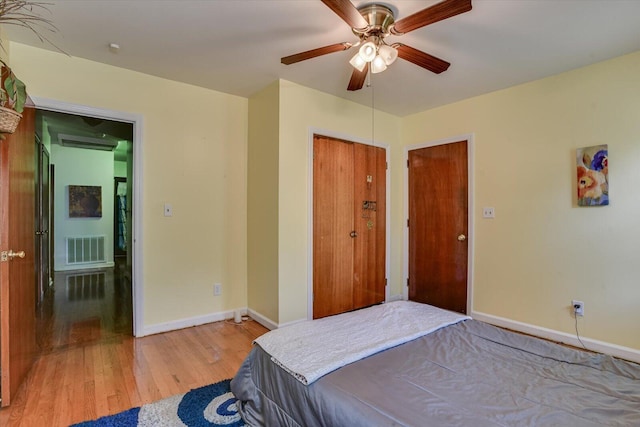 bedroom featuring ceiling fan, a closet, and wood-type flooring