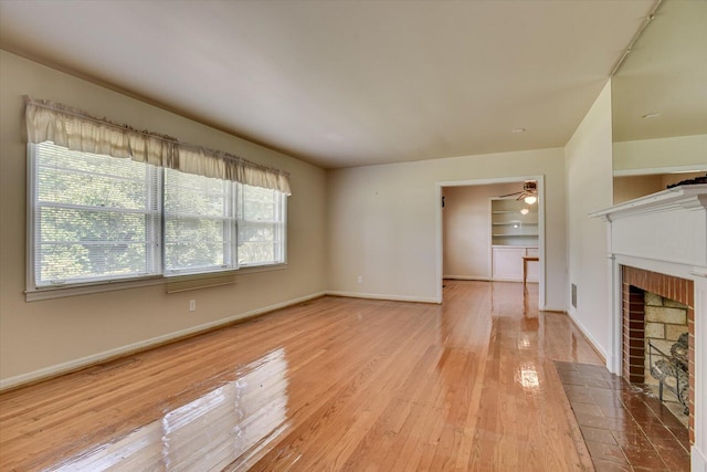 unfurnished living room with ceiling fan and light hardwood / wood-style floors