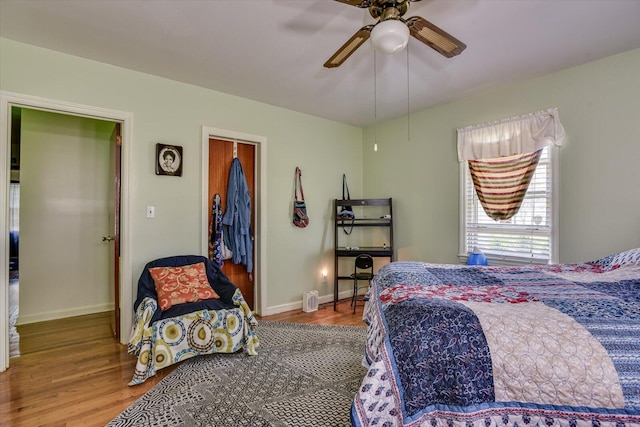 bedroom featuring wood-type flooring and ceiling fan