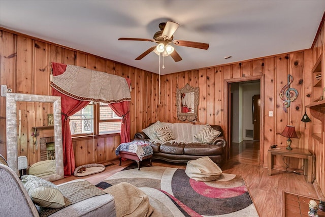 living room with light hardwood / wood-style flooring and ceiling fan