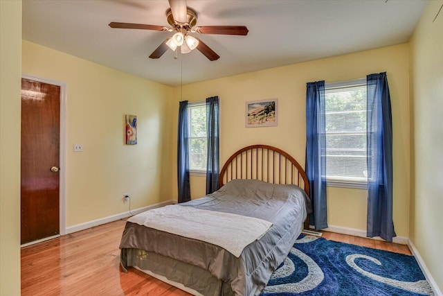 bedroom with ceiling fan and light hardwood / wood-style flooring