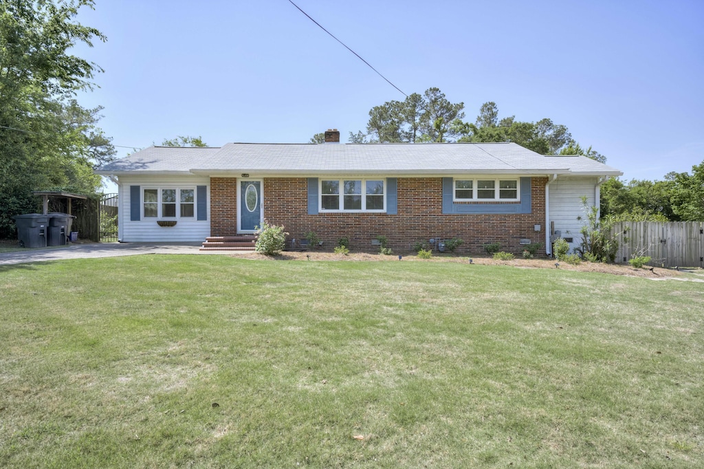 807 Springdale Rd, North Augusta, SC 29841 - ranch-style house with brick siding, a chimney, a front yard, and fence