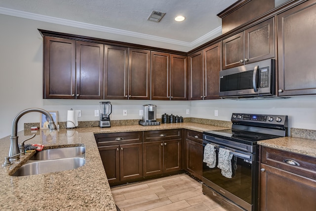 kitchen with light stone countertops, black electric range oven, ornamental molding, and sink